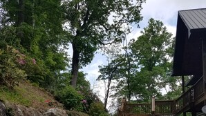 A stone staircase leading to a wooden cabin labeled "Cashiers Log Cabin."
