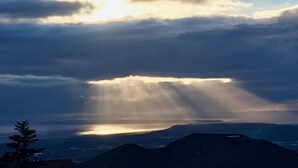 A mountain landscape with a view of the sun shining through clouds. - Best Views in Anchorage! Totally Private, Romantic, and Family Friendly Suite! (Anchorage)