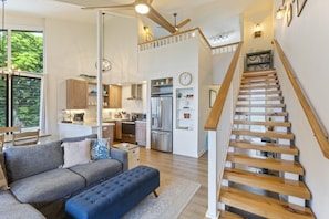 A modern interior with a staircase, a kitchen, and a living area.