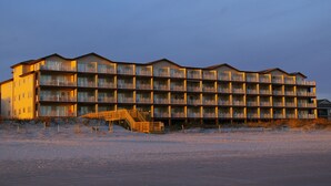 A multi-story hotel with balconies and a staircase leading to the entrance. - Oceanfront Heaven in Exclusive West End, Ocean Isle Beach, NC  (Ocean Isle Beach)