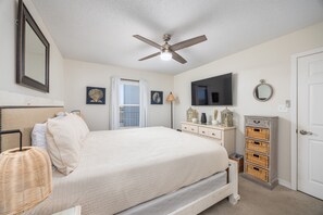 Relax in this inviting bedroom with a large bed, flat-screen TV, and dresser.