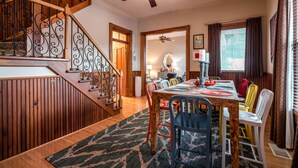 A dining area with a wooden table, chairs, and a ceiling fan. - The Highlands Hangout, EXPO, DOWNTOWN, restaurant row!!!  Game room & LOCATION! (Louisville)