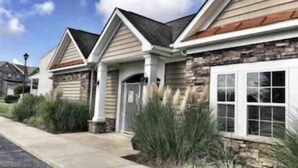 A residential building with a stone facade, a pitched roof, and a front entrance with a door and window. -     🏖️ Check out our off season discounted rates.  (Lewes)