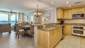 A modern kitchen with granite countertops, stainless steel appliances, and wooden cabinets.