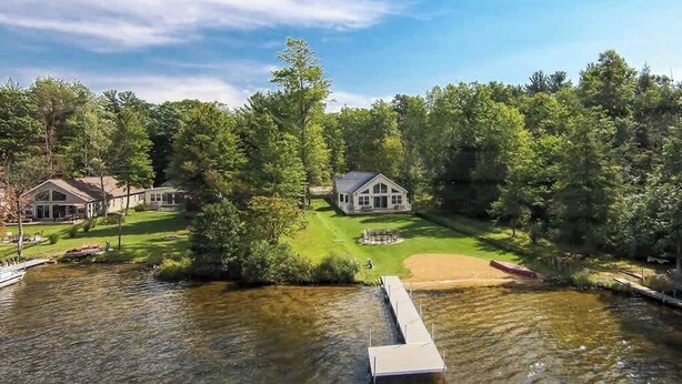 A lakeside property with a large house, a dock, and a well-maintained lawn. - Vast Open Floor Home with Fire Pit on the Lake (Pullman)