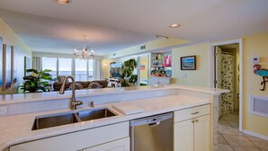 A modern kitchen with a large island, built-in dishwasher, and a view to the living area. - Wind Drift 603SE
Gulf Front
RECENT CANCELATION!!!
BOOK NOW! (Orange Beach)