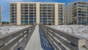 A boardwalk leading to a multi-story hotel with balconies and a sandy beach in the background. - Wind Drift 603SE
Gulf Front
RECENT CANCELATION!!!
BOOK NOW! (Orange Beach)