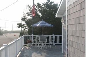 Enjoy a quiet moment in this outdoor seating area with a table and four chairs.