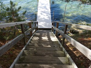 A wooden staircase leading to a dock over water. - Wickwood On Beautiful Big Twin Lake! (mancelona)