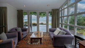 Ein Wohnzimmer mit Meerblick, ausgestattet mit Sofas und einem Couchtisch.