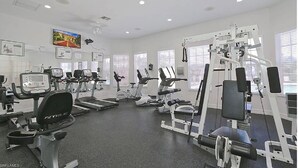 A gym with treadmills, elliptical machines, and weight equipment. - Beautiful Naples Condo (Naples)