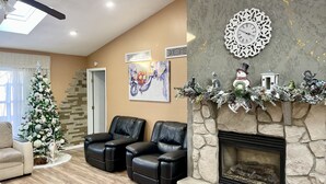 A living room with a fireplace, two leather chairs, a Christmas tree, and holiday decorations. - Peaceful house with hot tub, private swimming pool, etc.  (Albrightsville)