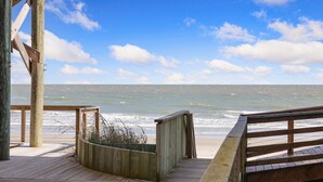 A wooden deck with a view of the ocean.