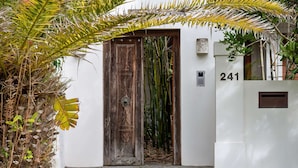A wooden door with a decorative design, a white wall with the number 241, and a small mailbox. - "La Cabane" - Private Pool (Copacabana)