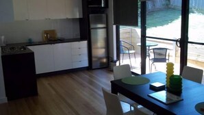 A modern kitchen with white cabinets, a black countertop, and a built-in stove.