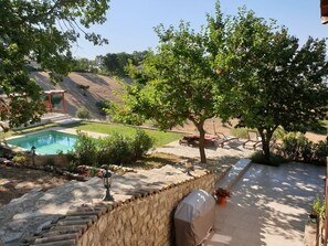 A backyard with a swimming pool, stone steps, a covered grill, and a pergola. - Luxury Farmhouse With Pool Close To The Sea (Palmoli)