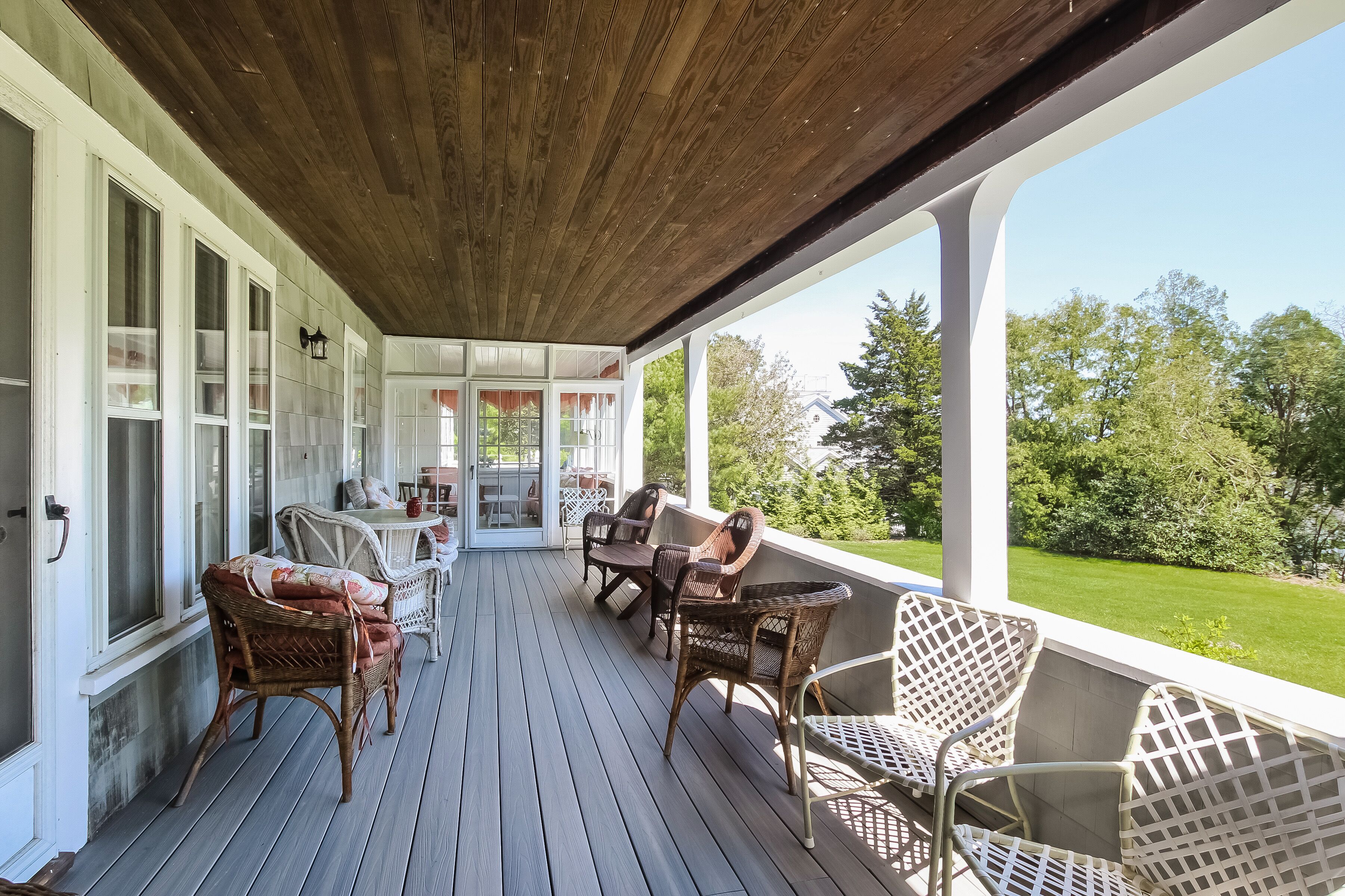 Back porch with ample seating and gas grill