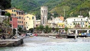 A coastal town with buildings, a tower, and boats. - Charming historical 4 guests apartment stunning sea view free wi- fi parking  (Monterosso al Mare)