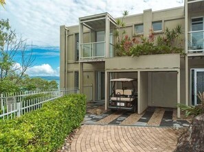 Experience the contemporary architecture of this multi-story building, featuring large windows and a flat roof design.