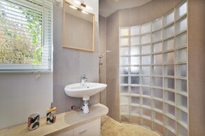 Shower, hair dryer, towels, toilet paper