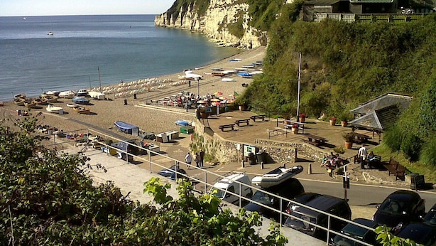 A coastal beach with boats, picnic areas, and a stone wall. - Gold Award winning cottage- with indoor heated pool and games area- pet friendly (Totnes)
