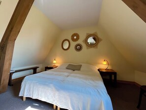 A bedroom with a bed, two bedside tables, and three wall-mounted mirrors. - House with garden (Grangues)