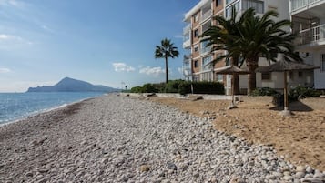 On the beach, sun-loungers