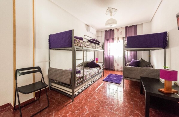 A dormitory room with bunk beds, a chair, a desk, and a lamp. - Spacious apartment with terrace. 3bed in the center (Madrid)