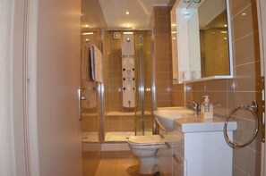 Shower, hair dryer, towels, toilet paper