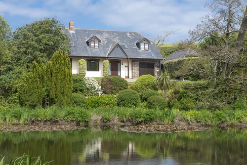 Overlooking the lakes of Roserrow, April Cottage is in an enviable location.