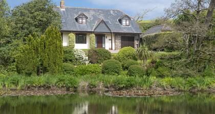 Overlooking the lakes of Roserrow, April Cottage is in an enviable location.