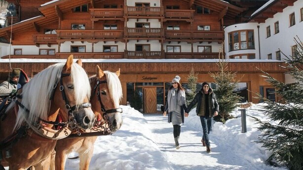 A wooden building with balconies and a sign that reads "Schlosserei." - Vitalhotel Tauernhof (Grossarl)
