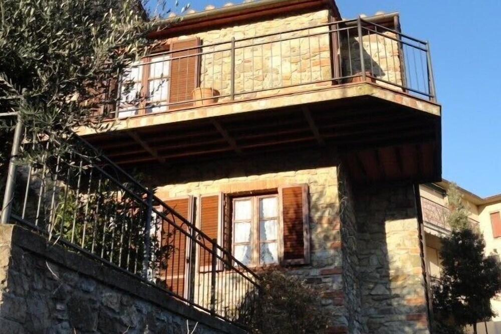 Beautiful stone house in Tuscany with terrace and balcony.