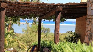 Una pérgola de madera con vista al mar.
