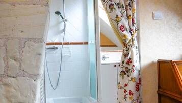 Bathtub, hair dryer, soap, toilet paper