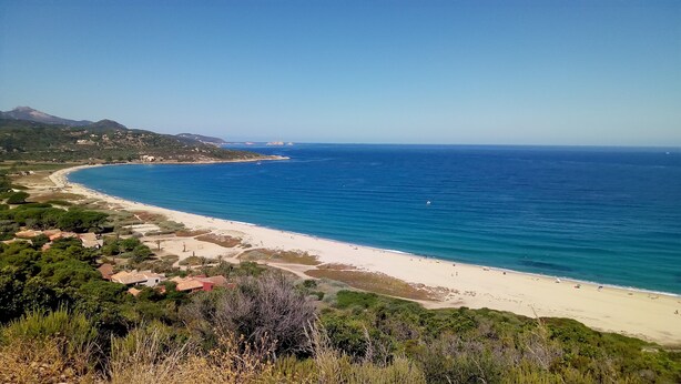 A coastal landscape with a beach, clear blue sea, and surrounding greenery. - CORSE APARTMENT DUPLEX 6 PEOPLE  (Palasca)