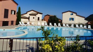 A swimming pool with white lounge chairs and a clear blue sky. - CORSE APARTMENT DUPLEX 6 PEOPLE  (Palasca)