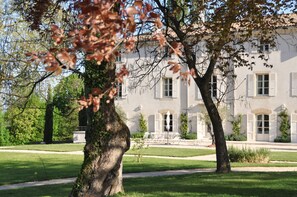 A large, historic building with a symmetrical facade, large windows, and a central entrance. - The Fruitier, 6p., at the beautiful « Domaine de Vincenti » (Domaine de Vincenti Divajeu)