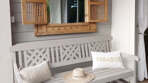 A white wooden bench with a woven hat and two pillows, one labeled "SUMMER" and the other "PARADISE". - BEAUTIFUL COUNTRY PROPERTY WITH PRIVATE POOL. HOLIDAYS TO YOU! (SAINTE ANNE)