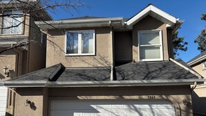 A two-story house with a garage, a chimney, and a stone foundation. - Oaks at Wasatch--call for discounted monthly off-season corporate rates (Cottonwood Heights)