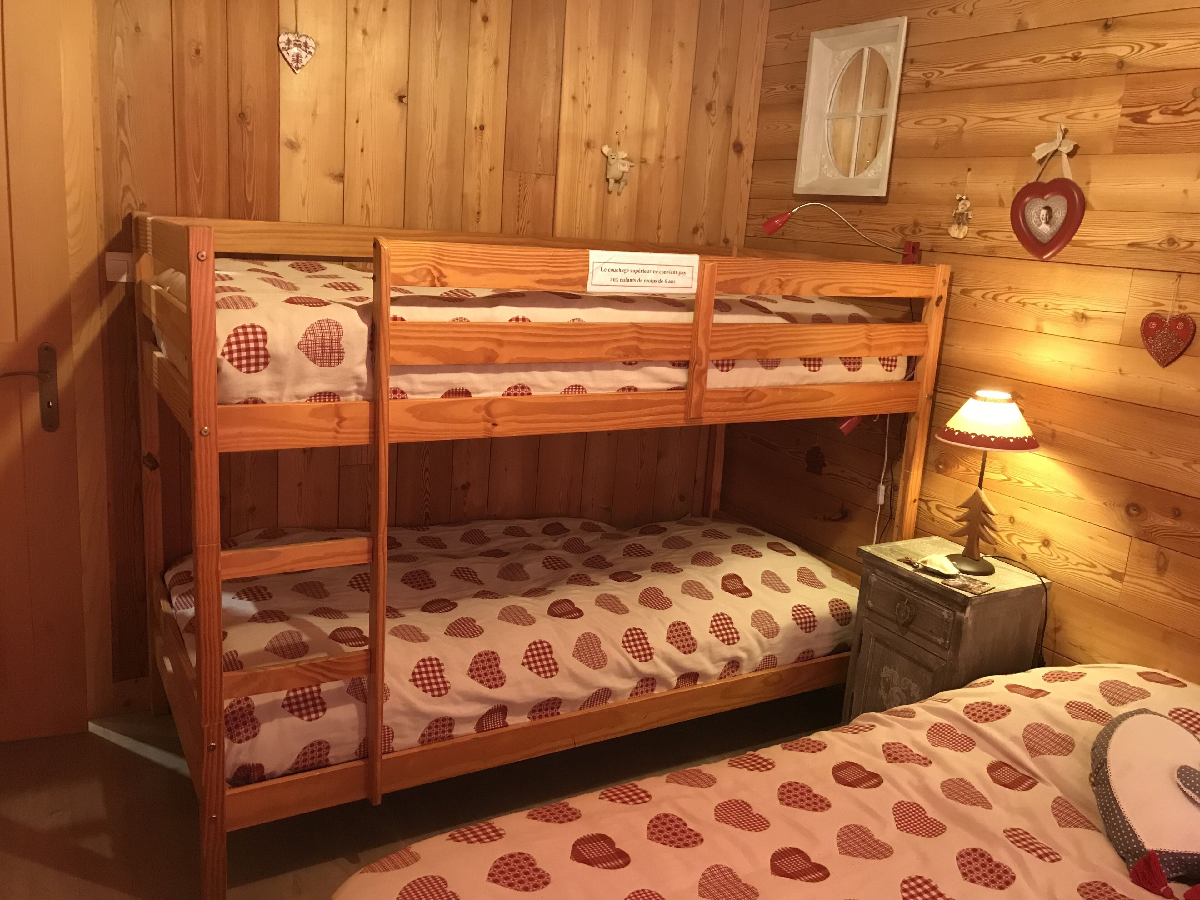 A bunk bed with a sign indicating a height restriction.
