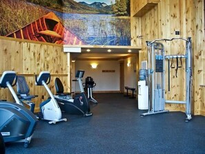 A gym with stationary bikes, treadmills, and a weight machine.
