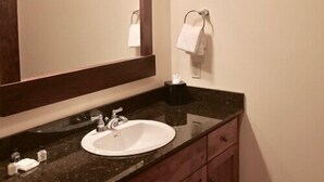 A bathroom with a large mirror, a sink, and a towel rack. - Veranda 4 Bedroom Unit 1 (Lake Placid)