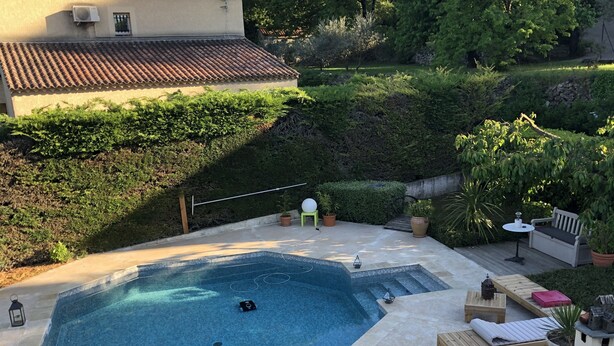 A swimming pool with a tiled deck, surrounded by potted plants and outdoor furniture. - Mimet <season 1/5 to 30/9 >week 630€ or 90€/nuit (Mimet)