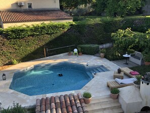 A swimming pool with a tiled deck, surrounded by potted plants and outdoor furniture. - Mimet <season 1/5 to 30/9 >week 630€ or 90€/nuit (Mimet)