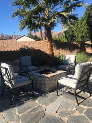 Relax by the fire pit in an outdoor space surrounded by comfortable seating.