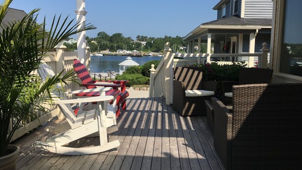 A wooden deck with outdoor furniture, a pergola, and a view of a marina and water. - Oceanside Retreat  Hubbards Nova Scotia (Hubbards)
