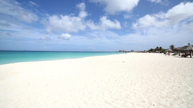 A wide sandy beach with a clear blue sky and calm turquoise sea. - 2 Bedroom, Beachfront, Amazing Ocean View, Modern ful (Eagle Beach)