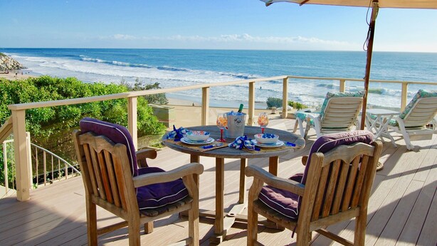 A wooden deck with a table set for two, overlooking the ocean. - Last Chance! Unexpected opening– Steps to the Beach! Spectacular roof deck (Santa Cruz)