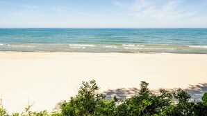 A beach with clear skies and calm waters. - 2024 remodeled historic Lake Michigan waterfront Union Pier home with spa. (Chikaming Township)